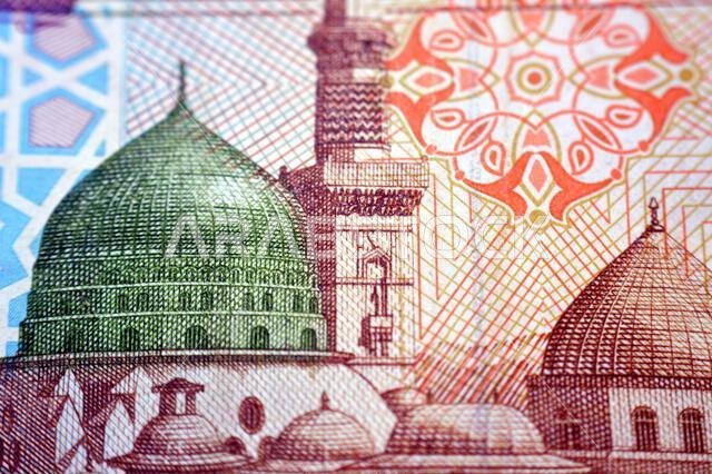 the Prophet's Mosque at Madina city from the obverse side of 100 SAR one hundred Saudi Arabian riyals cash money banknote bill, also features a portra