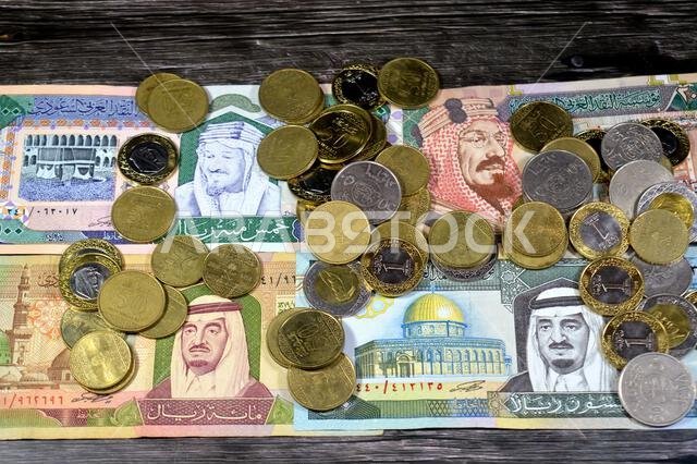 Saudi Arabian riyals SAR coins and banknotes cash money bills, of different times, eras and values, Saudi Arabia riyals money coin and banknote concep