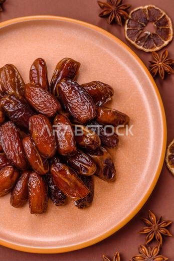 Dried dates in a ceramic plate, arabic food for the ramadan table. Dried dates as a food backdrop for your design.