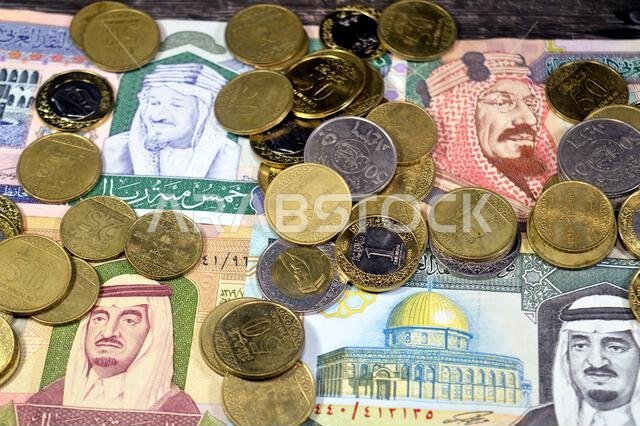 Saudi Arabian riyals SAR coins and banknotes cash money bills, of different times, eras and values, Saudi Arabia riyals money coin and banknote concep