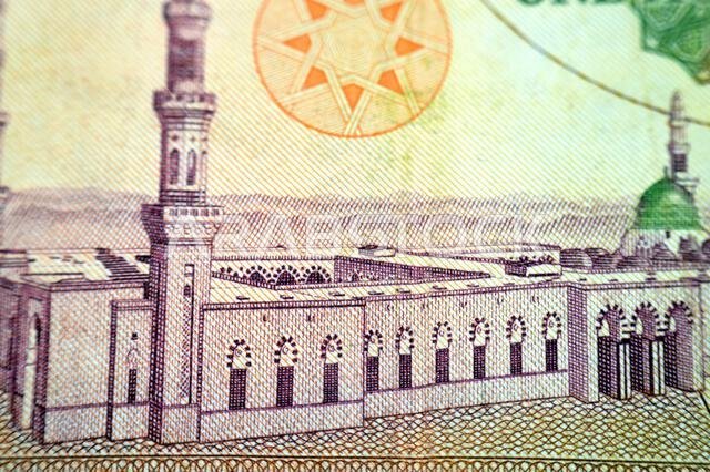 a general view of the Holy Prophet's Mosque at Madina from the reverse side of 100 SAR one hundred Saudi Arabian riyals cash money banknote bill, old