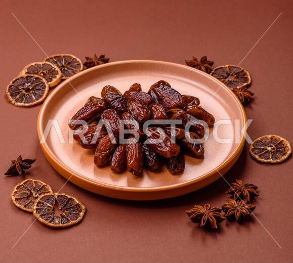 Dried dates in a ceramic plate, arabic food for the ramadan table. Dried dates as a food backdrop for your design.