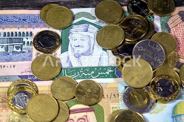 Saudi Arabian riyals SAR coins and banknotes cash money bills, of different times, eras and values, Saudi Arabia riyals money coin and banknote concep