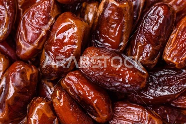 Dried dates in a ceramic plate, arabic food for the ramadan table. Dried dates as a food backdrop for your design.