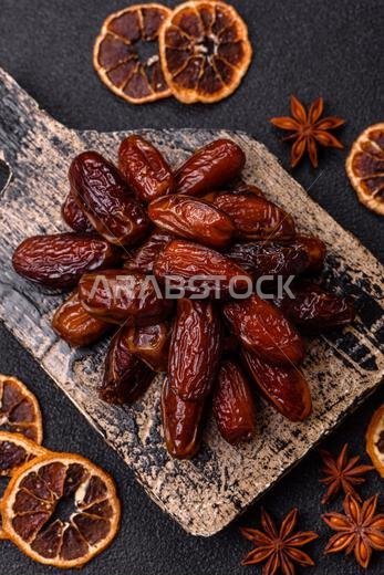 Dried dates in a ceramic plate, arabic food for the ramadan table. Dried dates as a food backdrop for your design.