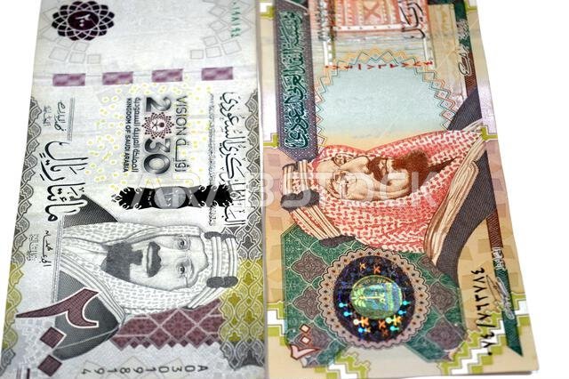 The obverse sides of old and new 200 SAR two hundred Saudi Arabia riyal cash money banknote bill, features King Abdulaziz Al Saud, Saudi Arabian money