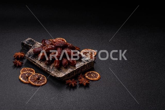 Dried dates in a ceramic plate, arabic food for the ramadan table. Dried dates as a food backdrop for your design.