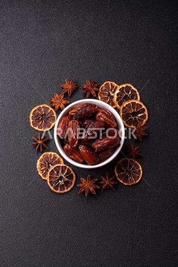 Dried dates in a ceramic plate, arabic food for the ramadan table. Dried dates as a food backdrop for your design.