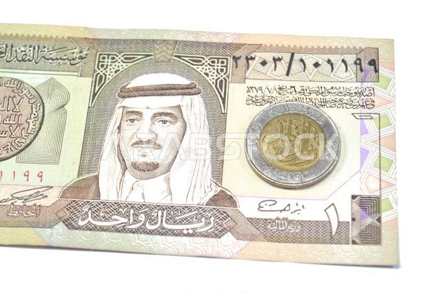 The reverse side of 1 SAR one Saudi Arabian Riyal coin features Denomination, Lettering, One Hundred Halalah, One Riyal 1419, on an old vintage retro