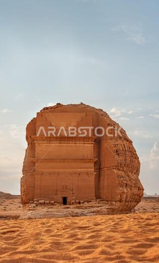 Tomb Lihyan Son of Kuza or Qasr al-Farid at Hegra, Saudia Arabia - most popular landmark in Mada'in Salih archaeological site, sandy desert landscape