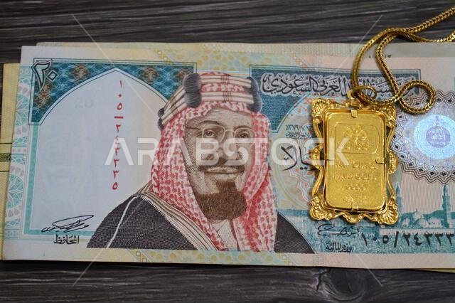 Cairo, Egypt, October 29 2025: A PAMP Suisse gold bar pendant on SAR Saudi riyals, 24K Gold Bar Half Ounce 15.55 Grams, pure fine gold 999.9, for inve Cairo, Egypt, October 29 2025: A PAMP Suisse gold bar pendant on SAR Saudi riyals, 24K Gold Bar Half Ounce 15.55 Grams, pure fine gold 999.9, for inve