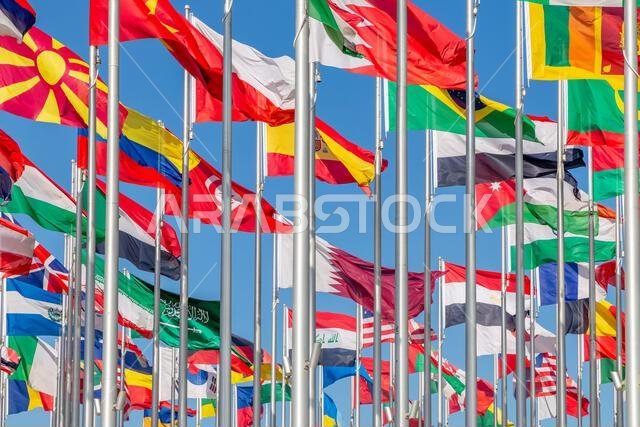 National flags of many countries waving in the wind, including Brazil, Spain, Saudi Arabia, Iraq, Oman, Sri Lanka, Macedonia, Ethiopia and Egypt, Doha