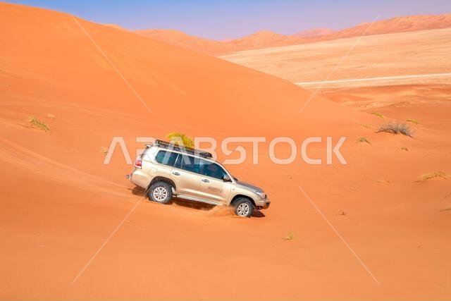 Wubar, Oman - Jan 7, 2024: 4wd car driving offroad in the desert roads to Saudi Arabia in Oman Empty Quarter desert, Rub' al-Khali.