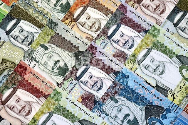 Saudi Arabia riyal money bills banknotes lies in big pile on table close up. Concept of finances and business in Saudi Arabia