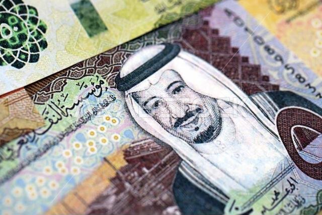 Saudi Arabia riyal money bills banknotes lies in big pile on table close up. Concept of finances and business in Saudi Arabia