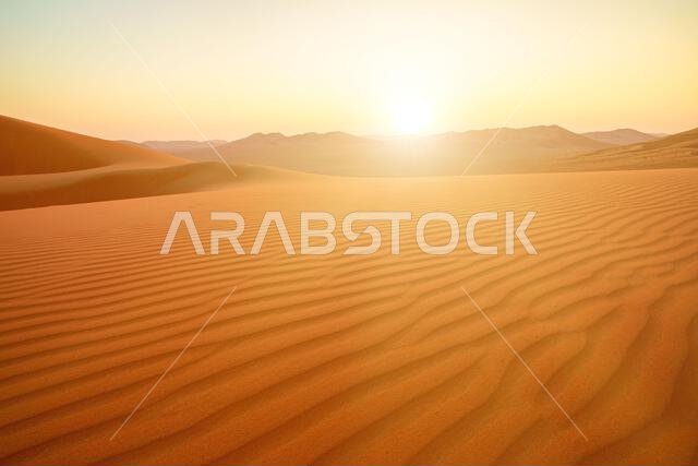 Endless horizons unfold in the panoramic vista of Oman's Empty Quarter, the Rub' al-Khali desert. Vast and serene, the landscape boasts undulating