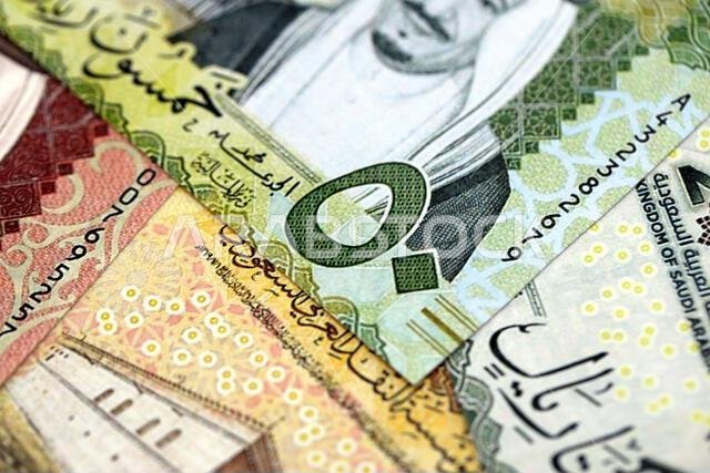 Saudi Arabia riyal money bills banknotes lies in big pile on table close up. Concept of finances and business in Saudi Arabia Saudi Arabia riyal money bills banknotes lies in big pile on table close up. Concept of finances and business in Saudi Arabia