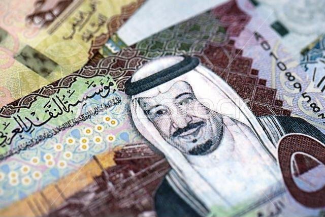 Saudi Arabia riyal money bills banknotes lies in big pile on table close up. Concept of finances and business in Saudi Arabia