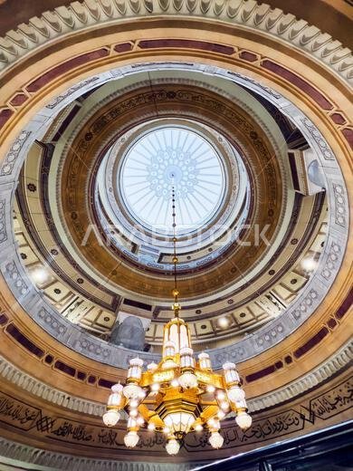 Mecca, Saudi Arabia – December 18, 2025: Golden chandelier hanging inside Masjid al-Haram, highlighting Islamic architectural interior lighting.