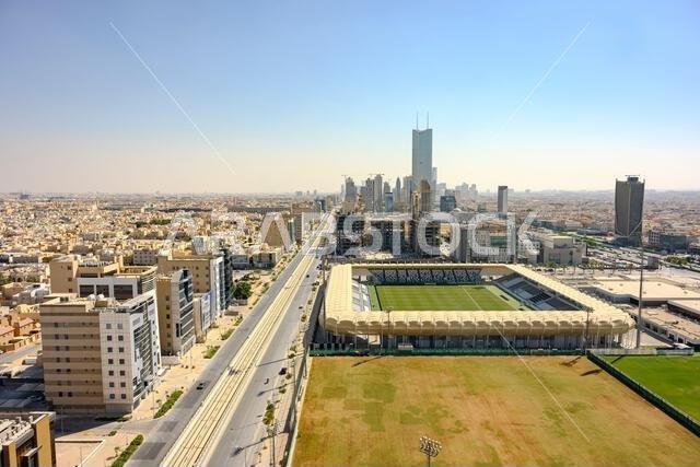 Riyadh Saudi Arabia city skyline. Elevated view revealing the expanding urban cityscape featuring a modern soccer stadium alongside ew construction. Riyadh Saudi Arabia city skyline. Elevated view revealing the expanding urban cityscape featuring a modern soccer stadium alongside ew construction.