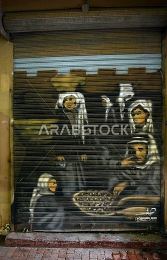 A corrugated metal shutter covered in graffiti at Souq-al-Zal in Riyadh, Saudi Arabia.
