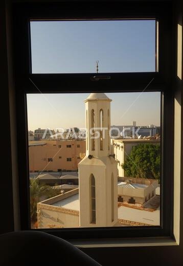 View over skyline including minaret of mosque from hotel window, Tabuk, Saudi Arabia