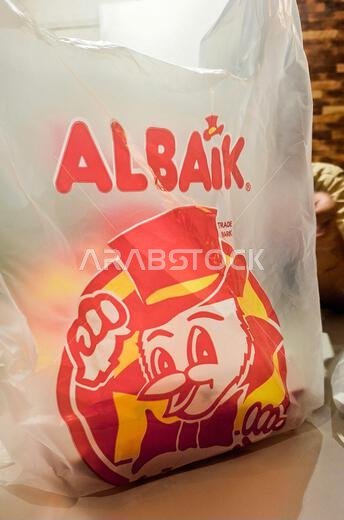 Makkah, Saudi Arabia - March 8, 2024: Take away from Albaik, one of the famous fast-food restaurants Makkah, Saudi Arabia - March 8, 2024: Take away from Albaik, one of the famous fast-food restaurants