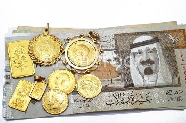 SAR Saudi Arabian riyals money banknotes and gold bars and The sovereign is a British gold coins, for investment or savings, 24 karat with highest lev