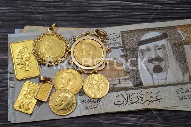 SAR Saudi Arabian riyals money banknotes and gold bars and The sovereign is a British gold coins, for investment or savings, 24 karat with highest lev