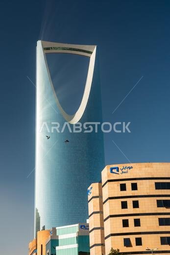 Riyadh, Saudi Arabia - January 1, 2026: Iconic The Kingdom Centre in Riyadh landmark soars above contemporary hotel architecture. The sail-shaped glass