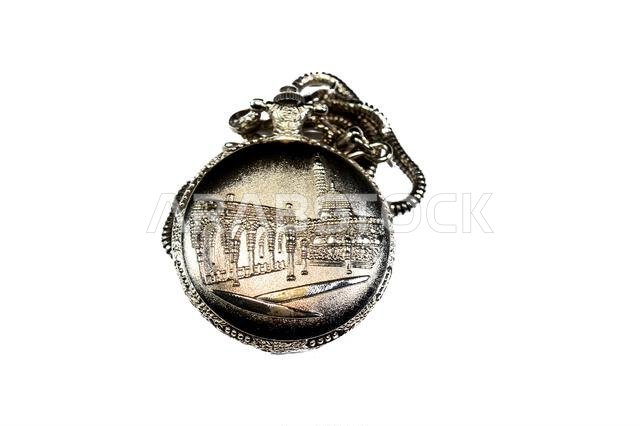 The prophet mosque in Medina on a silver colored pocket watch, pocket watch is a portable timepiece designed to be carried in a pocket, typically with