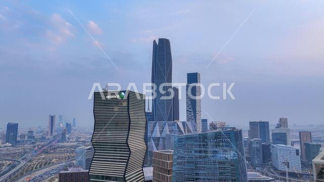 Aramco Tower with KAFD skyline and Riyadh cityscape in daytime, showing modern skyscrapers and urban development in Saudi Arabia.