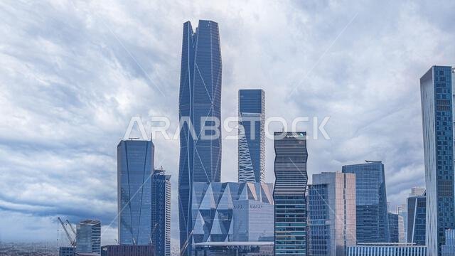 Aramco Tower with KAFD skyline and Riyadh cityscape in daytime, showing modern skyscrapers and urban development in Saudi Arabia.