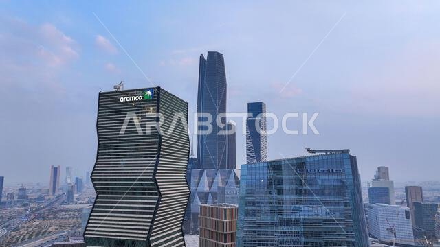 Aramco Tower with KAFD skyline and Riyadh cityscape in daytime, showing modern skyscrapers and urban development in Saudi Arabia.