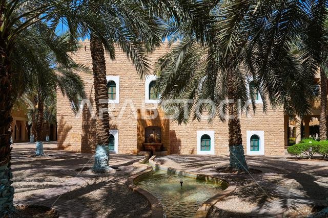 Traditional water fountain and palm grove at the historic Murabba Palace of Riyadh, Saudi Arabia