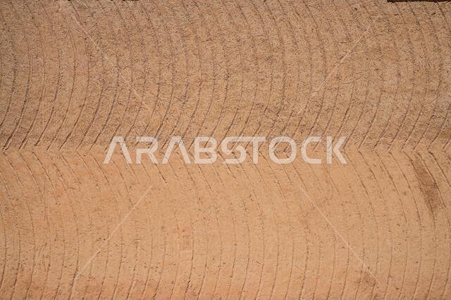 Traditional hand-finished mud-brick wall texture and Najdi architectural clay patterns in Riyadh, Saudi Arabia