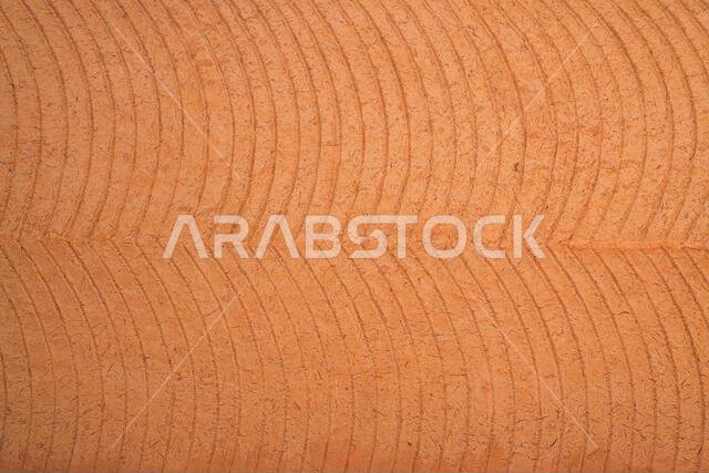 Traditional hand-finished mud-brick wall texture and Najdi architectural clay patterns in Riyadh, Saudi Arabia