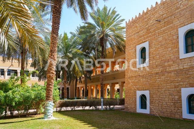Lush palm trees in the gardens of Murabba Historical Palace in Riyadh, Saudi Arabia