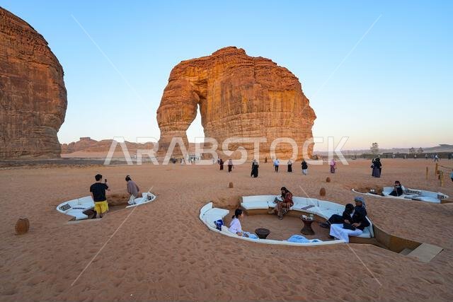 Luxury desert lounge at the foot of Elephant Rock (Jabal Al-Fil) at sunset in the desert of AlUla, Saudi Arabia