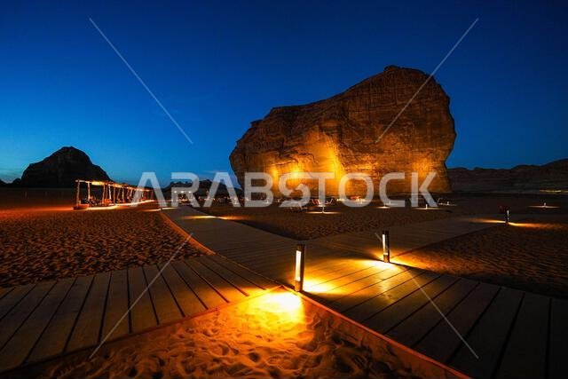 Wooden boardwalk leading to the iconic Elephant Rock in AlUla at dusk, Saudi Arabia