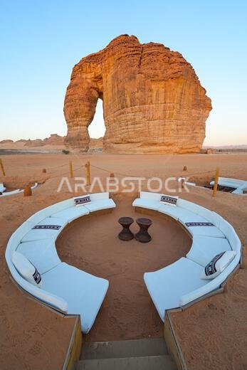 Luxury desert lounge at the foot of Elephant Rock (Jabal Al-Fil) at sunset in the desert of AlUla, Saudi Arabia