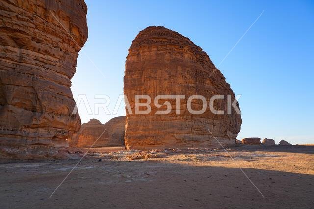 Sandstone rock formation next to Elephant Rock (Jabal Al-Fil) at sunset in the desert of AlUla, Saudi Arabia