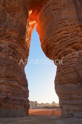 Natural arch of the Elephant Rock (Jabal Al-Fil) at sunset in the desert of AlUla, Saudi Arabia