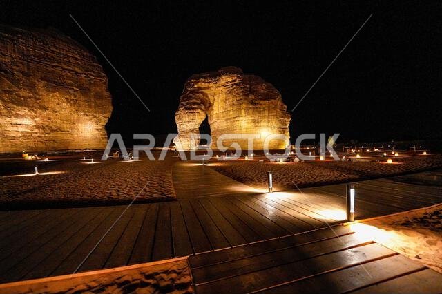 Wooden boardwalk leading to the iconic Elephant Rock in AlUla at night, Saudi Arabia