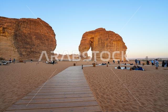 Wooden boardwalk leading to the iconic Elephant Rock in AlUla at sunset, Saudi Arabia