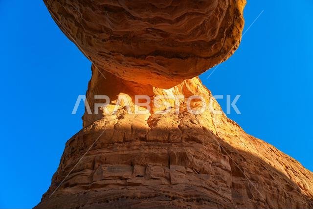 Bottom side of the natural arch of Elephant Rock (Jabal Al-Fil) at sunset in the desert of AlUla, Saudi Arabia