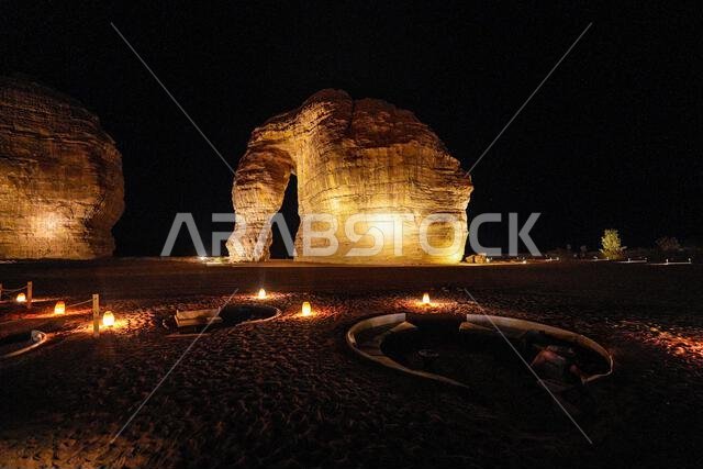 Luxury desert lounge at the foot of Elephant Rock (Jabal Al-Fil) at night in the desert of AlUla, Saudi Arabia