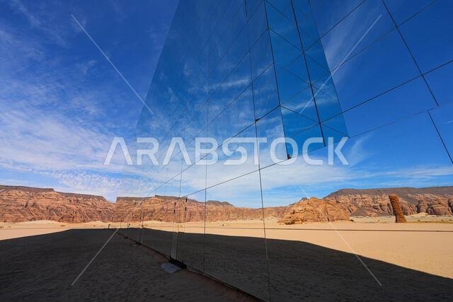 The Maraya mirrored concert hall reflecting the ancient desert mountains of Ashar Valley in AlUla, Saudi Arabia