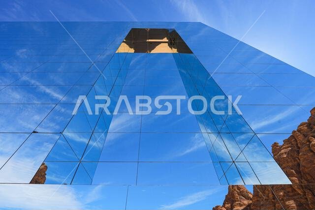 The Maraya mirrored concert hall reflecting the ancient desert mountains of Ashar Valley in AlUla, Saudi Arabia