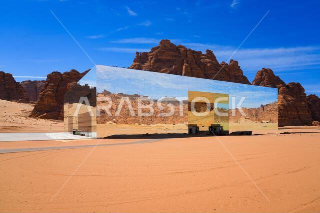 The Maraya mirrored concert hall reflecting the ancient desert mountains of Ashar Valley in AlUla, Saudi Arabia